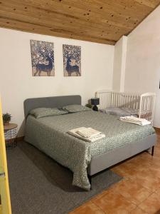a bedroom with a bed and two pictures on the wall at Retiro da Lua in Montargil
