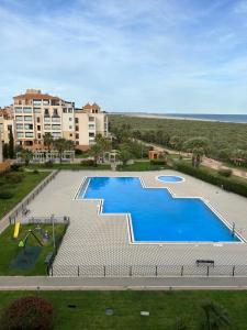 an overhead view of a swimming pool in a resort at A estribor in Isla Canela