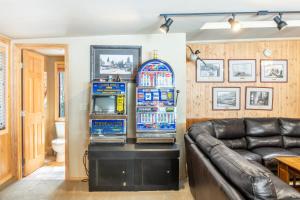 two slot machines in a living room with a couch at Frosted Shore by AvantStay Luxury Lake Views in Incline Village