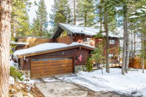 a log home with a garage in the snow at Frosted Shore by AvantStay Luxury Lake Views in Incline Village