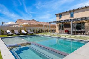 a swimming pool in the backyard of a house at Desert Eden by AvantStay 6BR w Ensuite Backyard Oasis w Pool Hot Tub in Coachella