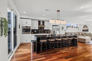 a kitchen and living room with a bar with stools at Luxury Townhome 2 Car Garage and Decks 2 Billiards Room in Philadelphia