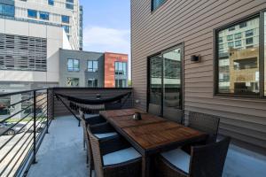 a patio with a wooden table and chairs on a balcony at Luxury Townhome 2 Car Garage and Decks 2 Billiards Room in Philadelphia