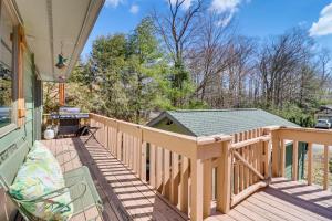 a wooden deck with a bird house on it at Lovely Tobyhanna Getaway with Game Room and Fire Pit! in Tobyhanna
