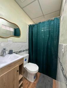 a bathroom with a toilet and a sink and a shower at Casa moderna a la vuelta de metrocentro San Miguel in San Miguel