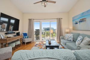 a living room with a couch and a table at Sea Tales in Oak Island