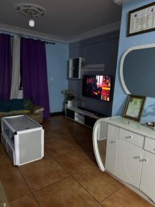 - un salon avec une table et une télévision dans l'établissement Maqueda 2. Sanjo, à Malabo
