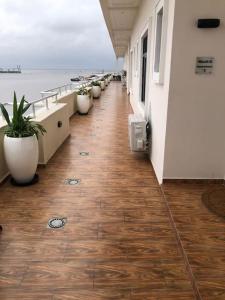 a corridor of a building with potted plants at Exquisite 3BR Penthouse with Waterfront Views in Lekki