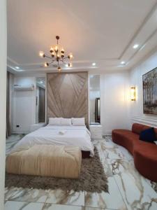 a large bedroom with a large bed and a couch at Exquisite 3BR Penthouse with Waterfront Views in Lekki