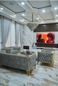 a living room with a couch and a television at Exquisite 3BR Penthouse with Waterfront Views in Lekki