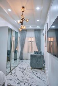 a living room with a couch and a mirror at Exquisite 3BR Penthouse with Waterfront Views in Lekki