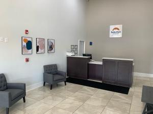 an office with two chairs and an office desk at Suburban Studios in Cordele