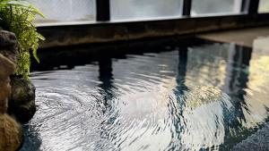 a large pool of water in a building with at Yufuin Akarinoyado in Yufuin