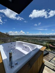 a white bath tub sitting on top of a balcony at Montecielo Hosting in Guatapé