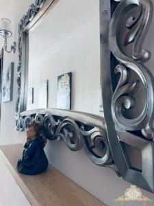 a small child sitting on the floor under a large mirror at Casa belvedere in Anzio