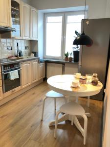 a kitchen with a table and chairs in a kitchen at Amber in Gdańsk