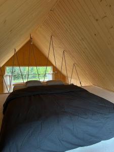 a room with a large bed in a tent at Sunny Houses domki rekreacyjne in Sobótka