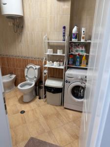 ein Badezimmer mit einem WC und einer Waschmaschine in der Unterkunft Tirana Centre New Lions Gate 3 Apartment in Tirana