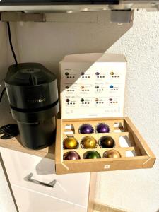 a box of ornaments on a counter next to a coffee maker at Wohnung nähe Porsche Museum in Stuttgart