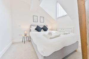 a white bedroom with a large bed and a window at Modern 2 Bedroom Apartment in Central Nottingham in Nottingham