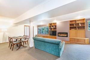a living room with a blue couch and a table at Beachview Bungalow Warrnambool in Warrnambool