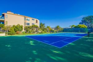 a tennis court in front of a house at Cozy Coastal Condo in Solana Beach
