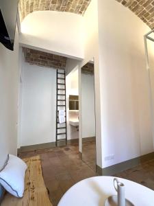a room with a ladder and a room with a mirror at RESIDENZA ORTENSIA in Petacciato +66 photos