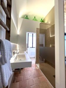 a bathroom with a white sink and a mirror at RESIDENZA ORTENSIA in Petacciato