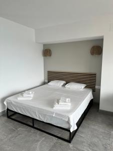 a bedroom with a bed with two towels on it at Aloha Playa Sol y Mar in Benalmádena