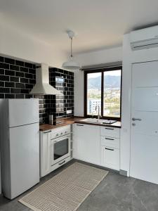 a kitchen with white appliances and a large window at Aloha Playa Sol y Mar in Benalmádena +7 photos