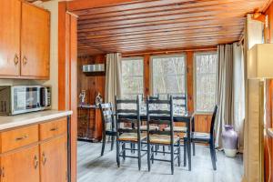 a dining room with a table and chairs in a kitchen at Massachusetts Cabin Rental Near Hiking and Skiing! in Ashburnham