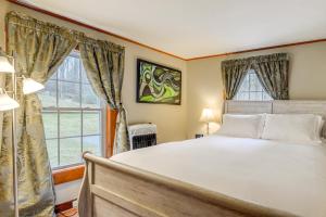 a bedroom with a large bed and a window at Massachusetts Cabin Rental Near Hiking and Skiing! in Ashburnham
