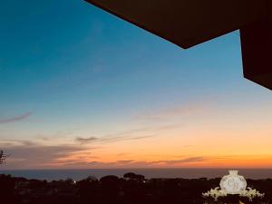 a view of the sunset from the balcony of a house at Casa belvedere in Anzio