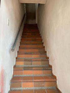a staircase in an old building with orange tiles at Apartamentosla23 in Valledupar