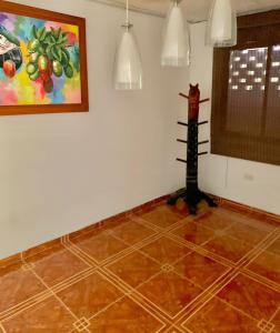 a room with a painting and a cat on the wall at Apartamentosla23 in Valledupar