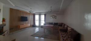 a living room with a table and a couch at Tranquil Oasis in the Heart of Ifrane in Ifrane