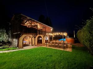 a barn with a bunch of lights on it at night at Le Cottage in Furdenheim