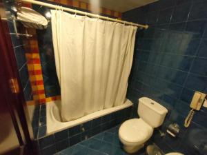 a bathroom with a toilet and a shower curtain at INGOING Marina in El Alamein
