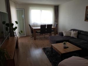 a living room with a couch and a table at Ferienwohnung Sun Mountain 3 Zimmer 72qm Rechberghausen Sonnenberg in Rechberghausen