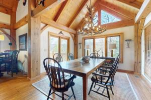 a dining room with a wooden table and chairs at Sunset Ridge in Sapphire