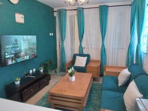 a living room with a couch and a table at KilimanjaroHansel 1 BR with AC and Backup Gen in Kisumu
