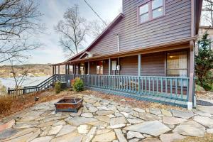 a house with a stone patio in front of it at Lakefront Chateau in Pulaski