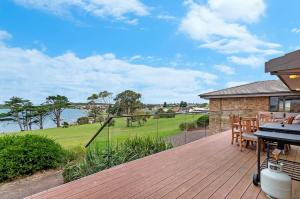a deck with a table and a grill on a house at Hopkins View Holiday Home in Warrnambool