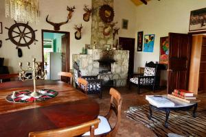 a living room with a wooden table and a fireplace at Villa cuatro pisos el tramonto in Guatavita
