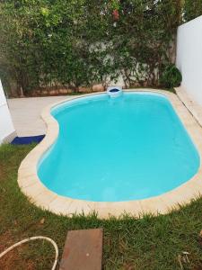 a small blue swimming pool in the grass at Nassali - Beautiful Villa in Tamaris in Casablanca