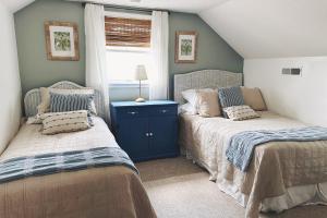 a bedroom with two beds and a window at Firefly Cottage in Edisto Beach +33 photos