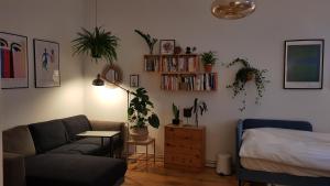 a living room with a couch and a bed at Cozy room in Neukölln , Kreuzberg in Berlin
