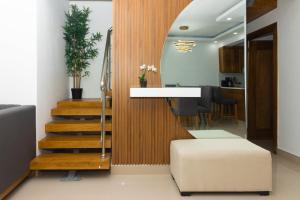 uma sala de estar com uma escada e um espelho em Modern Luxury Apt w Outdoor Jacuzzi em Santiago de los Caballeros