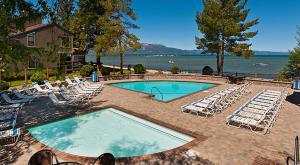 a swimming pool with lounge chairs and a large swimming pool at Lakeland Village 426 - Lakeland Luxury - Remodeled in South Lake Tahoe