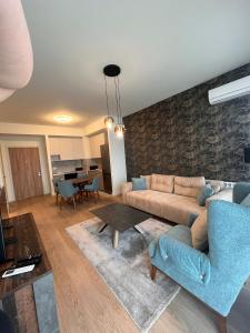een woonkamer met een bank en een tafel bij Belgrade Waterfront Zvoncica Apartament in Belgrado